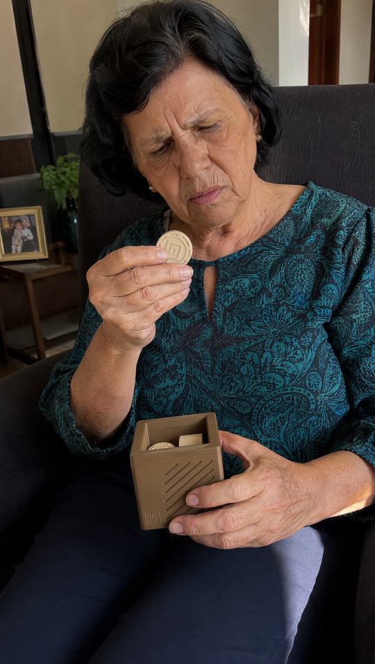 Mulher examinando de perto um disco do Nigma P2, com o cubo apoiado no colo